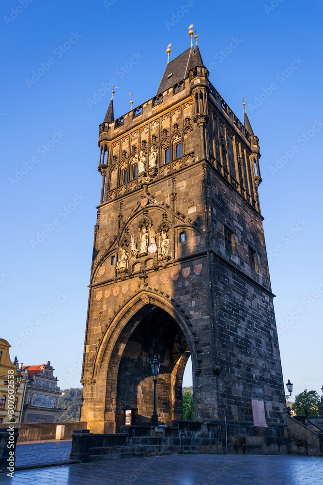 Old Town Bridge Tower guarding end of the Charles Bridge and entrance to Old Town of Prague, Czech Republic, sunny summer morning