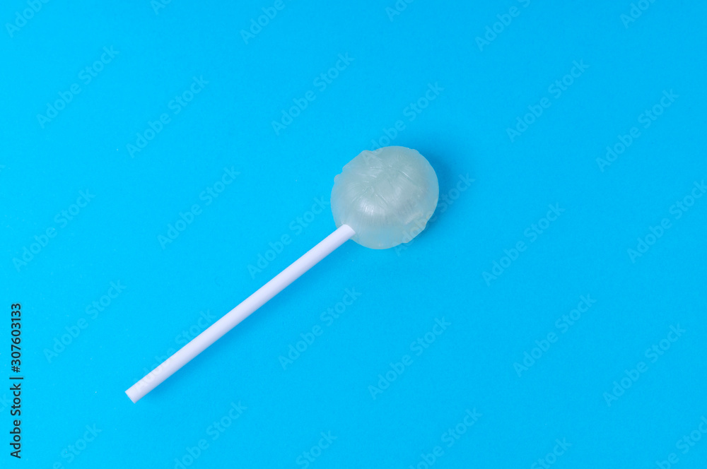melon-flavored Lollipop on blue background background, mock up, copy space, text space melon-flavored Lollipop on blue background background, mock up, copy space, text space