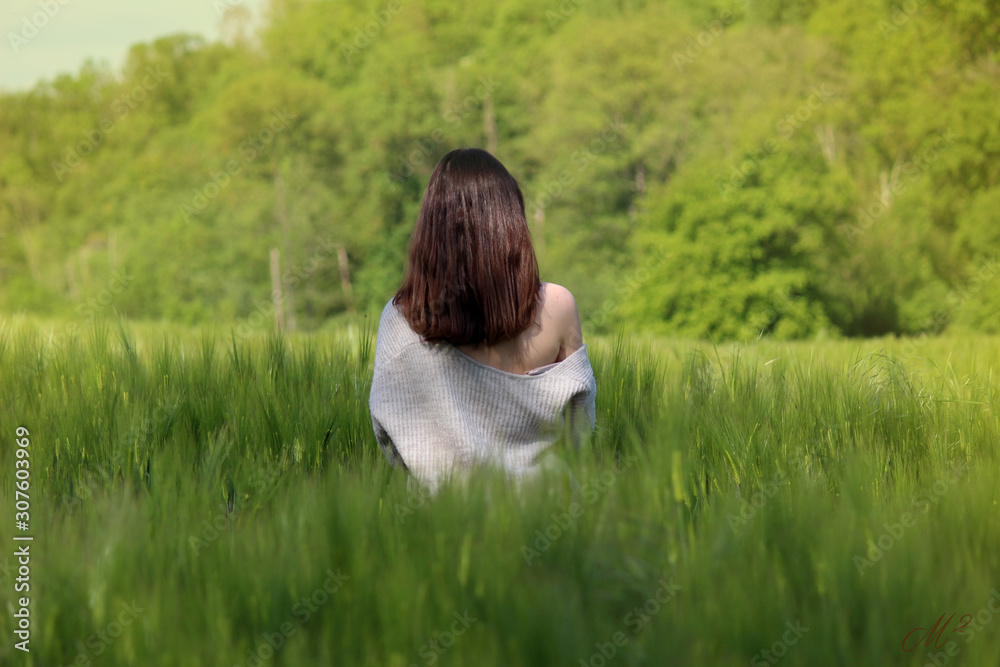 young woman lying on grass