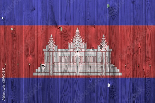 Cambodia flag depicted in bright paint colors on old wooden wall. Textured banner on rough background photo