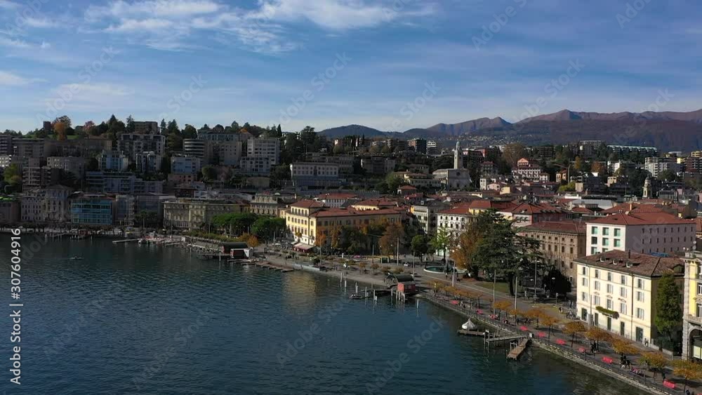 Panoramic view of the city of Lugano, its lakefront and his buildings on a beautiful sunny day by drone. Panoramic view of the city of Lugano, its lakefront and his buildings on a beautiful sunny day by drone.