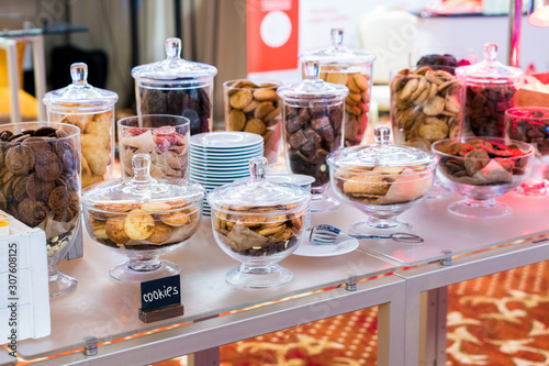 Shortbread cookies in glassware and other sweets on the buffet table during the coffee break