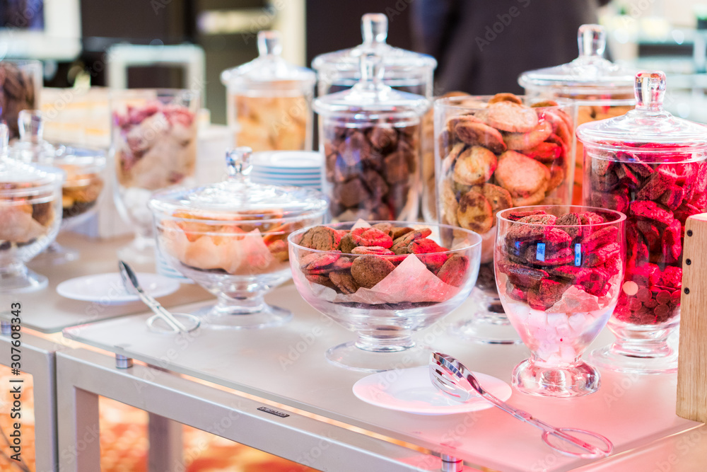 Shortbread cookies in glassware and other sweets on the buffet table during the coffee break