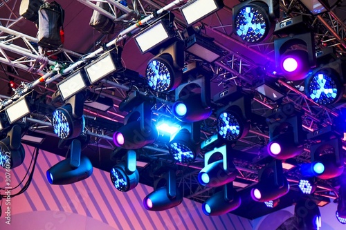 Set of professional stage lighting equipment for gig illumination.Floodlights,several powerful  stage light, used to illuminate also sports field, stage, or exterior of  building.Stage illumination. photo