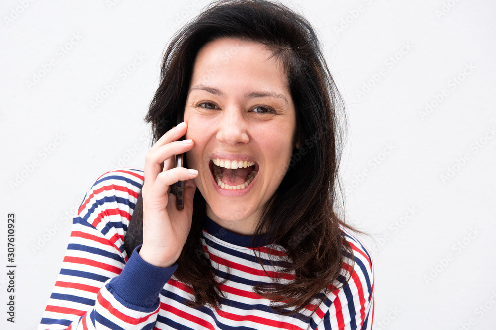 Close up happy woman talking with phone by white background Close up happy woman talking with phone by white background