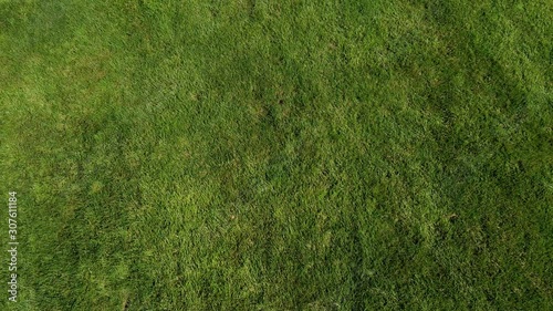 A grass field taken from a drone ascending with a slight twist.  This sod is clean and the only thing on screen. Drone. photo