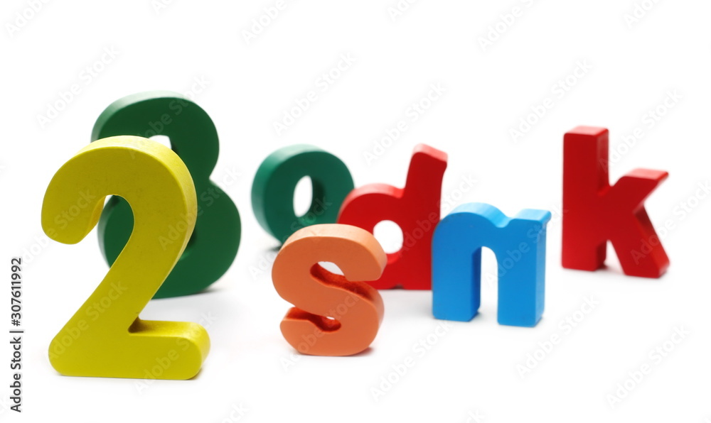 Colorful wooden alphabet, spelling and number blocks, isolated on white background Colorful wooden alphabet, spelling and number blocks, isolated on white background
