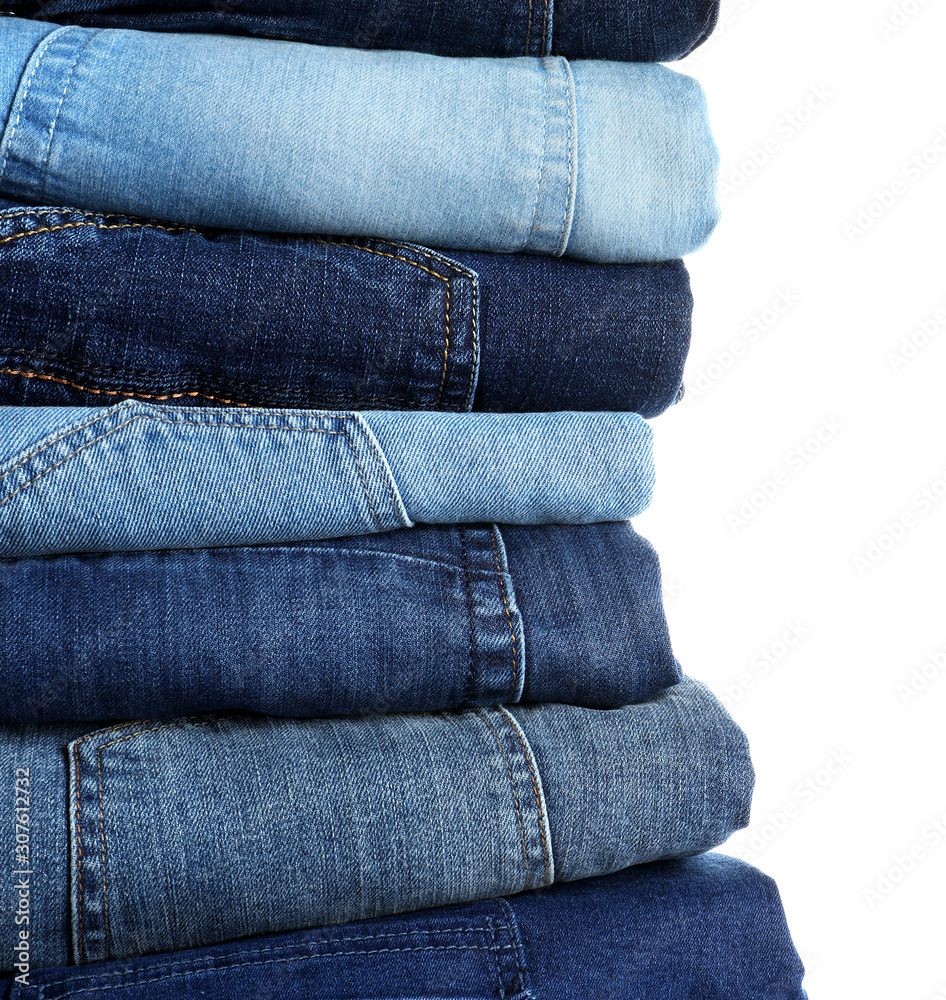 Stack of different jeans isolated on white