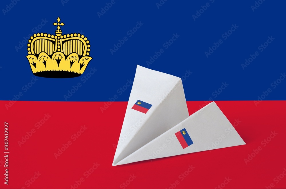 Liechtenstein flag depicted on paper origami airplane. Handmade arts concept - obrazy, fototapety, plakaty 