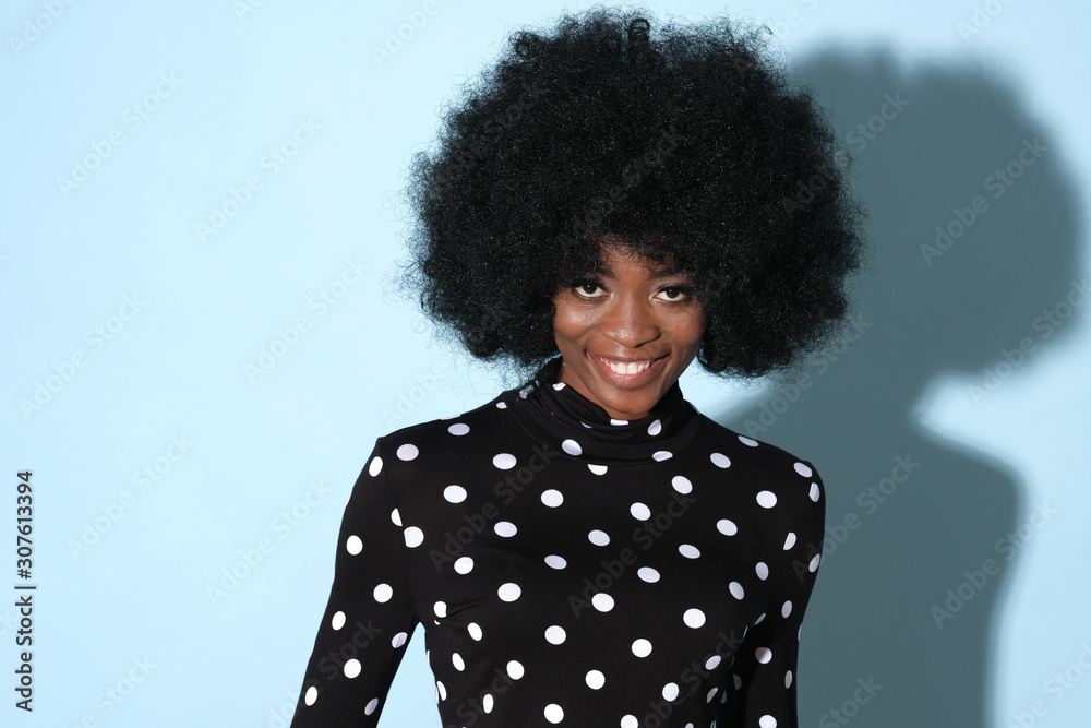 Smiling african model with afro hair wearing a geometric pattern golf. Smiling african model with afro hair wearing a geometric pattern golf.