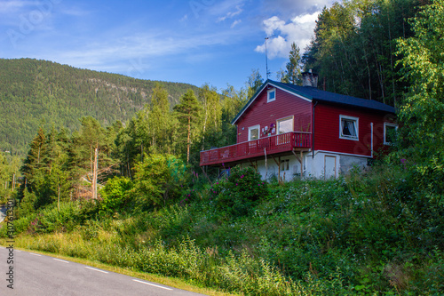 There is a house in forest at the end of city Otta. Norway photo