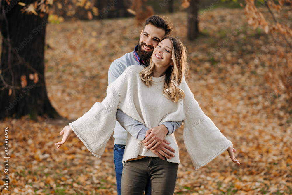 Smiling couple relaxing together outdoors and enjoying in autumn day Smiling couple relaxing together outdoors and enjoying in autumn day