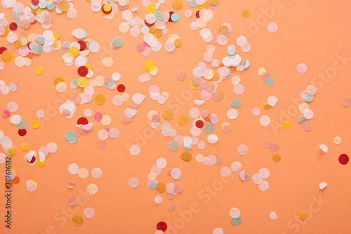 decorative and colorful confetti on orange background photo