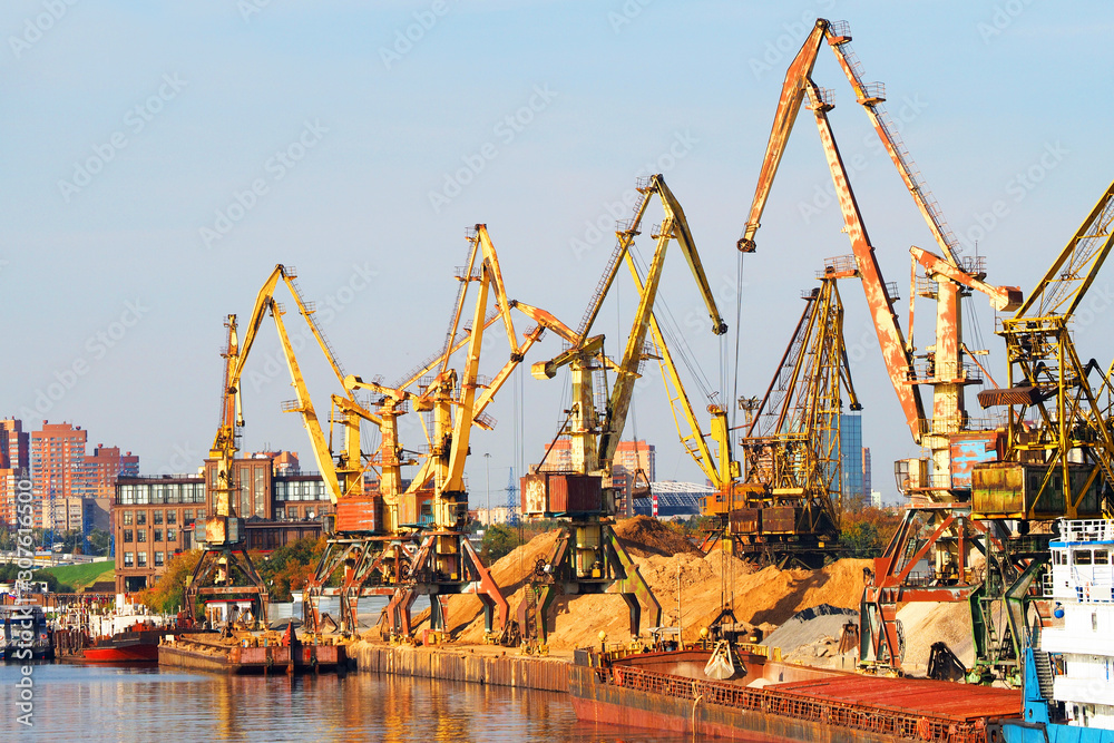 Work of the cargo port, loading barges with sand