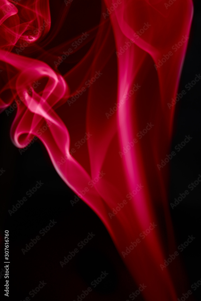 Obraz premium single colored smoke aginst black background