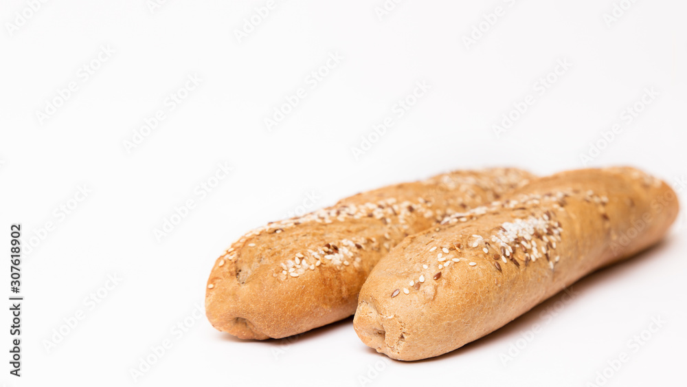 two French baguette with sesame seeds on a white background two French baguette with sesame seeds on a white background