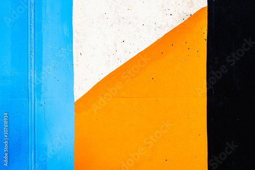 Textured background of a wall painted with black, orange and white lines. © Joaquin Corbalan