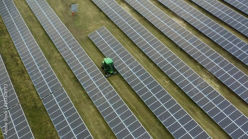 Drone shot of grass being cut at solar power plant photo