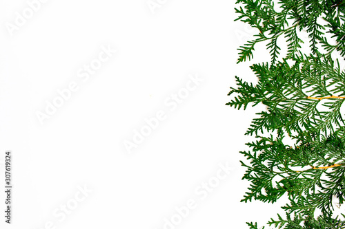 Christmas and New Year background with thuja branch, decorations and presents wrapped in craft paper with snowflakes. Flat lay, top view