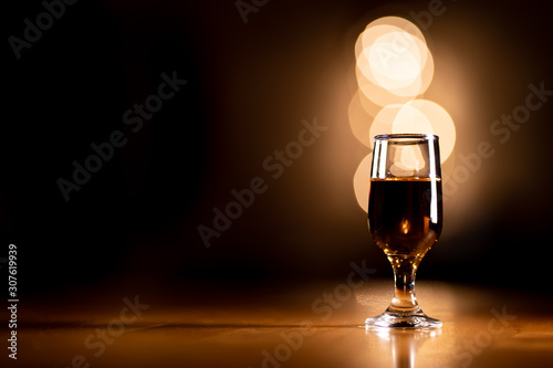 Glass of Bourbon Whiskey on a Wooden Table with Copy Space