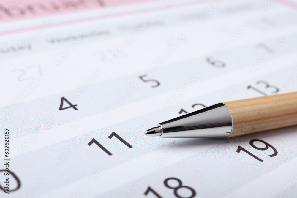 Pen on calendar page, closeup. Planning concept Pen on calendar page, closeup. Planning concept