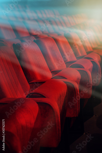 Movie theater empty auditorium with red seats and blue lighting