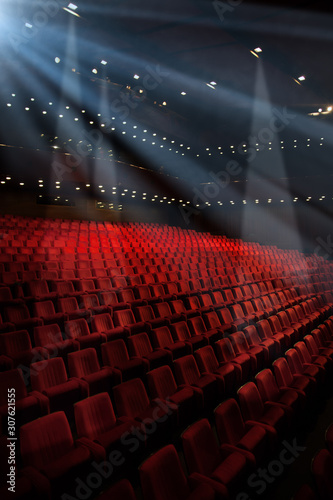 Movie theater empty auditorium with red seats and blue lighting