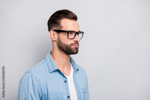 Closeup photo of amazing macho guy serious looking empty space young promoted boss chief wear specs casual denim outfit isolated grey color background