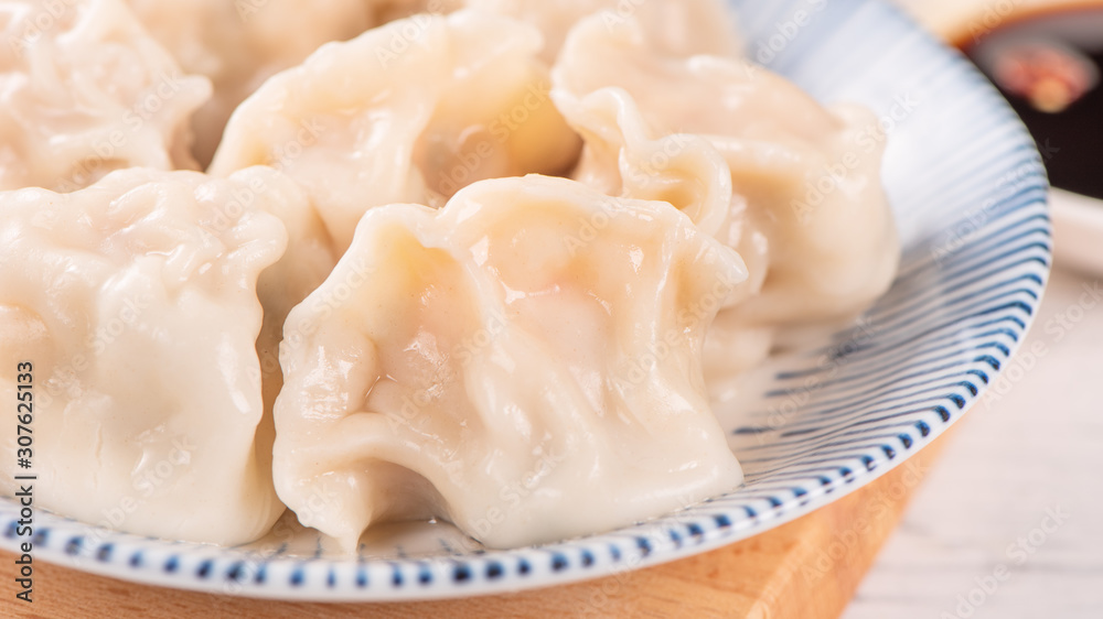 Fresh, delicious boiled pork gyoza dumplings, jiaozi on white background with soy sauce and chopsticks, close up, lifestyle. Homemade design concept. Fresh, delicious boiled pork gyoza dumplings, jiaozi on white background with soy sauce and chopsticks, close up, lifestyle. Homemade design concept.