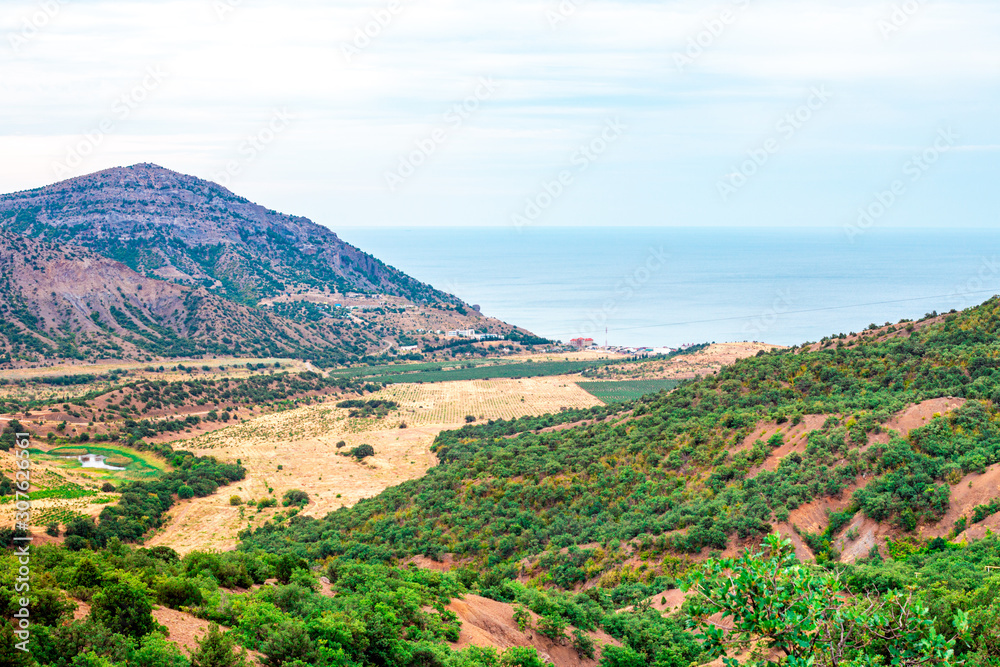 Crimean mountain landscape and the sea shore in the distance