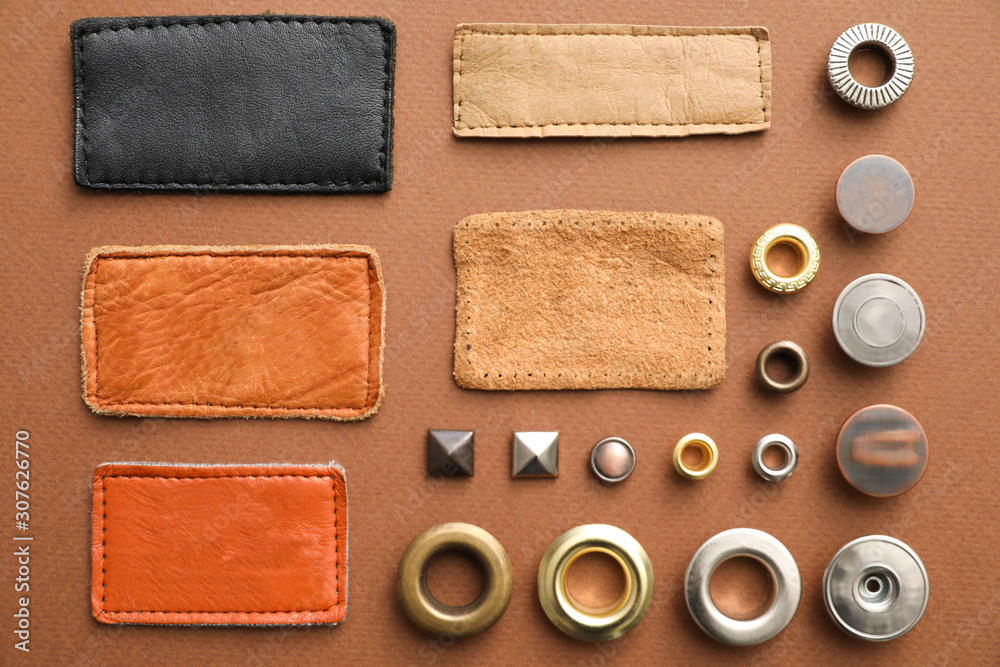 Fototapeta premium Flat lay composition with garment accessories for jeans on brown background