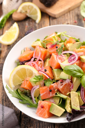 salad with salmon fillet, avocado, onion and lettuce