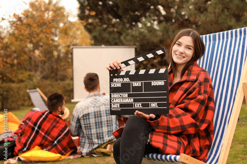 Happy young woman with movi...