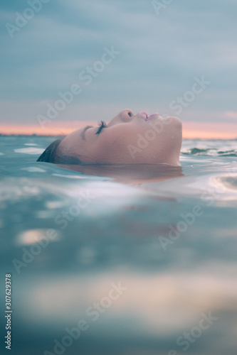 Asian model in the water enjoying a wellness spa.