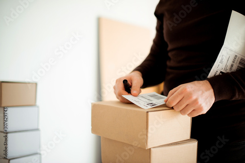 Delivery service, applying a shipping label  © Stock Rocket
