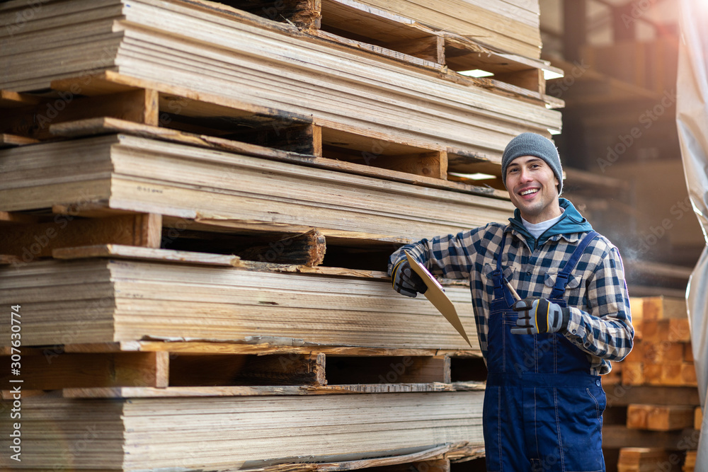 Fototapeta premium Young male worker in timber warehouse 