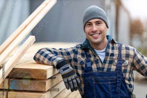 Fototapet Young male worker in timber warehouse