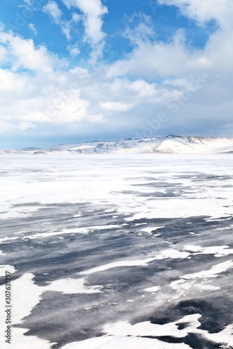 Winds and blizzards typical of winter Lake Baikal. Small Sea Strait and Olkhon Island on a February day. Beautiful winter landscape. Cold natural background