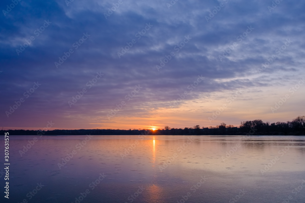 Ice on the frozen Lake and cirrus clouds in the sky before sunrise. Beautiful ukrainian landscape Ice on the frozen Lake and cirrus clouds in the sky before sunrise. Beautiful ukrainian landscape