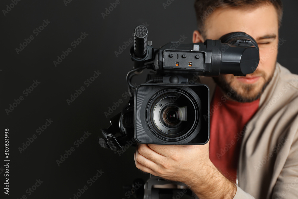 Operator with professional video camera on black background Operator with professional video camera on black background