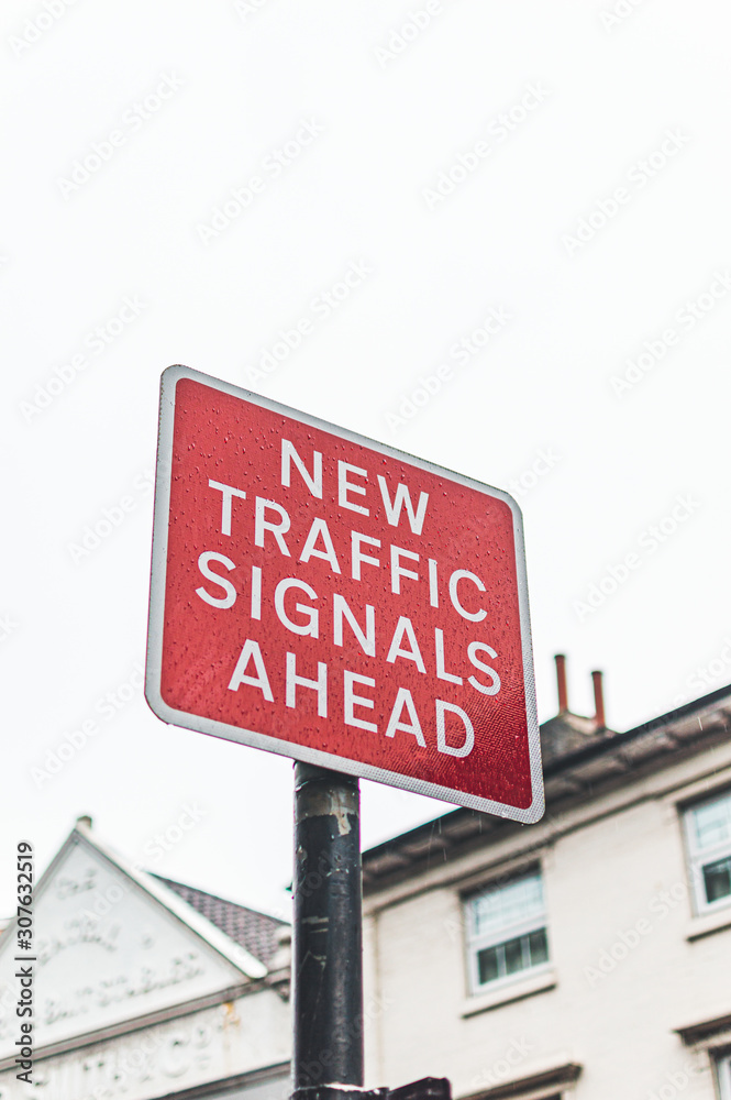 Red street sign with white letters saying ,,new trafic signaks ahead,, Red street sign with white letters saying ,,new trafic signaks ahead,,