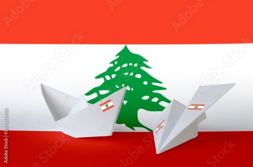 Lebanon flag depicted on paper origami airplane and boat. Handmade arts concept photo