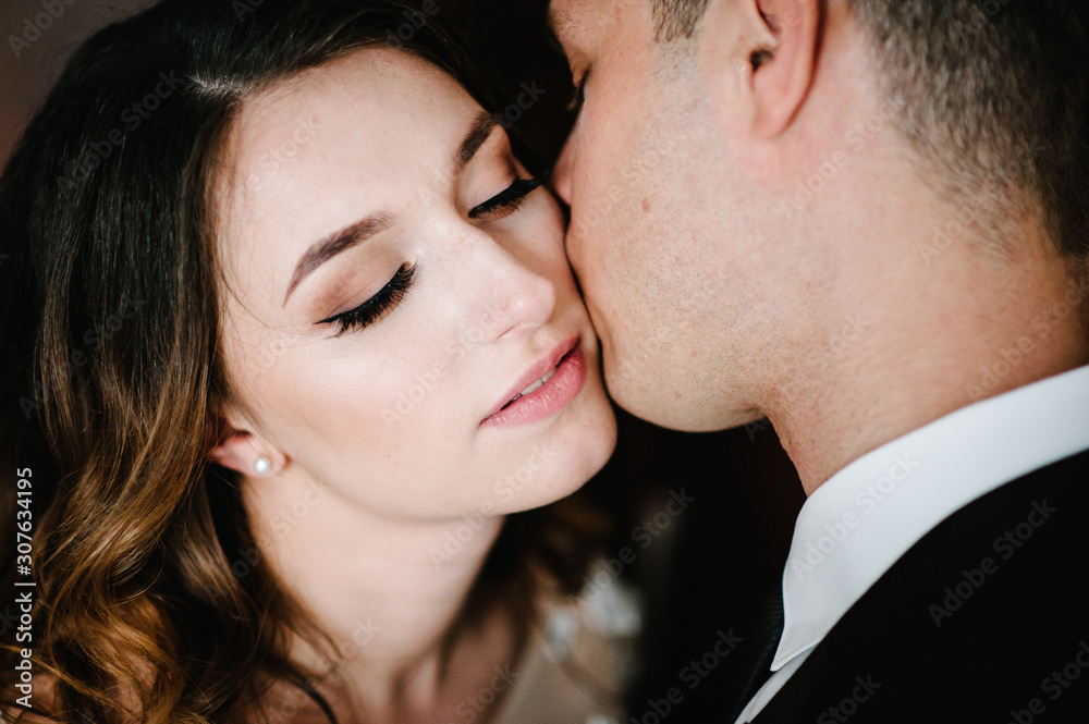 Romantic photo. Man hugs lovingly a tender woman. Young couple in love on Valentine's day. Close up. Romantic photo. Man hugs lovingly a tender woman. Young couple in love on Valentine's day. Close up.
