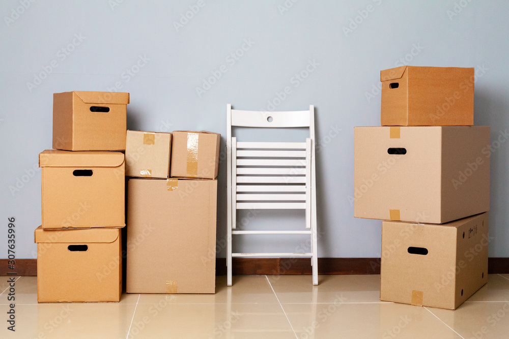 Moving boxes with packed stuff and chair for moving Moving boxes with packed stuff and chair for moving