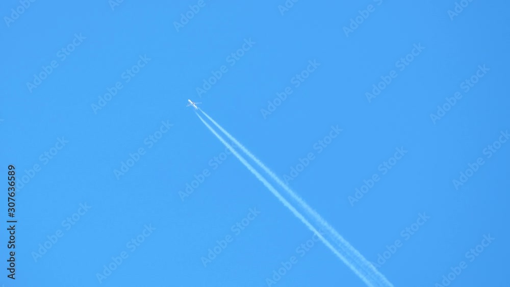 Cinemagraph of airplane with contrail in blue sky Cinemagraph of airplane with contrail in blue sky