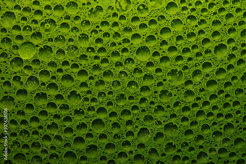 Abstract liquid background fresh green vegetable juice with water bubbles, geometric circles chlorophyll