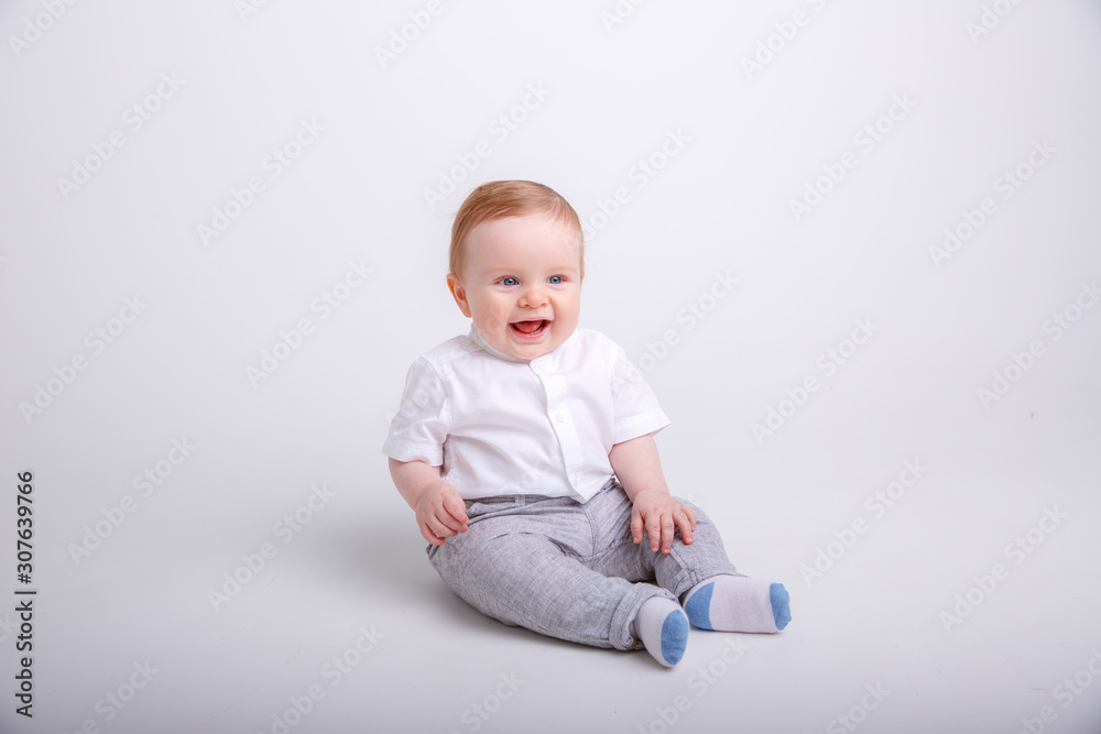 baby boy sitting on a white background. portrait of child smiling isolated on white background baby boy sitting on a white background. portrait of child smiling isolated on white background