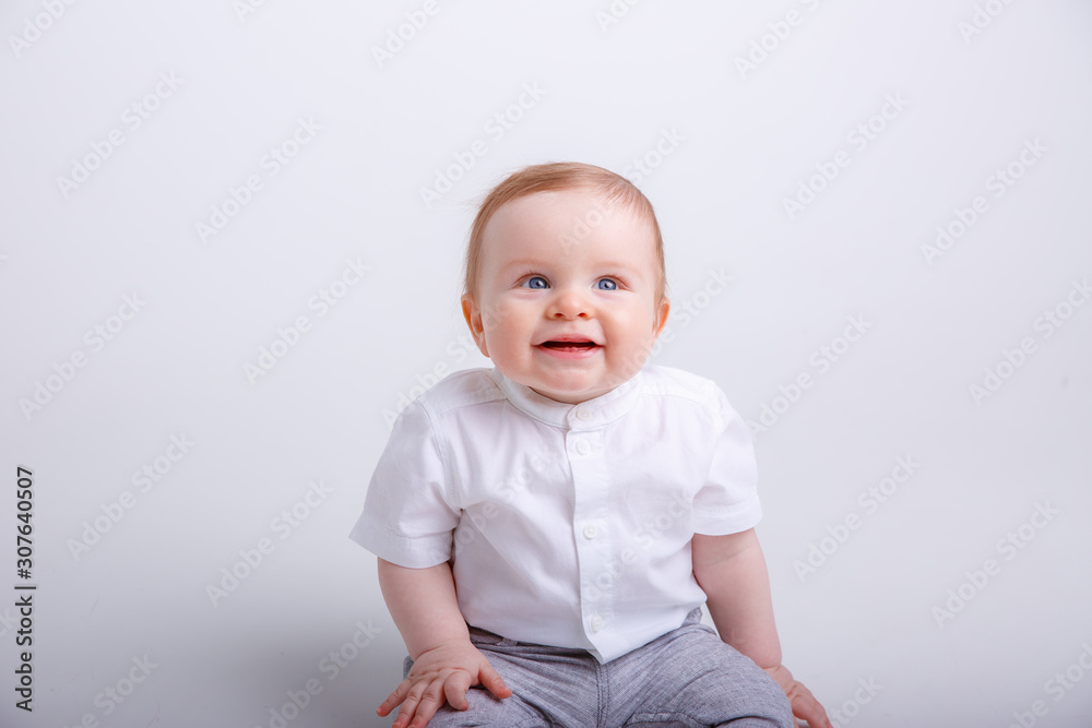 baby boy sitting on a white background. portrait of child smiling isolated on white background baby boy sitting on a white background. portrait of child smiling isolated on white background
