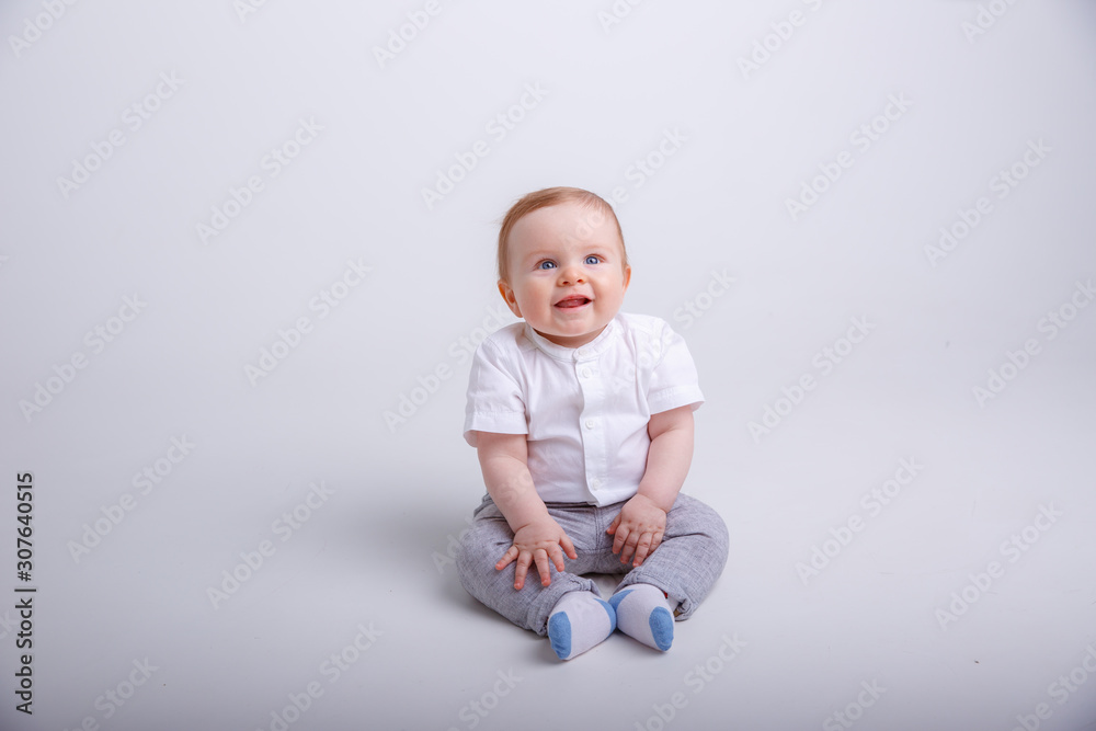 baby boy sitting on a white background. portrait of child smiling isolated on white background baby boy sitting on a white background. portrait of child smiling isolated on white background