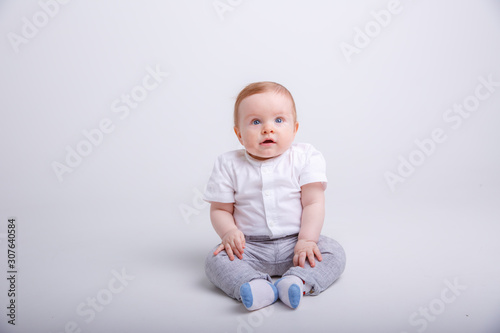 portrait of child smiling isolated on white background. baby boy sitting on a white background